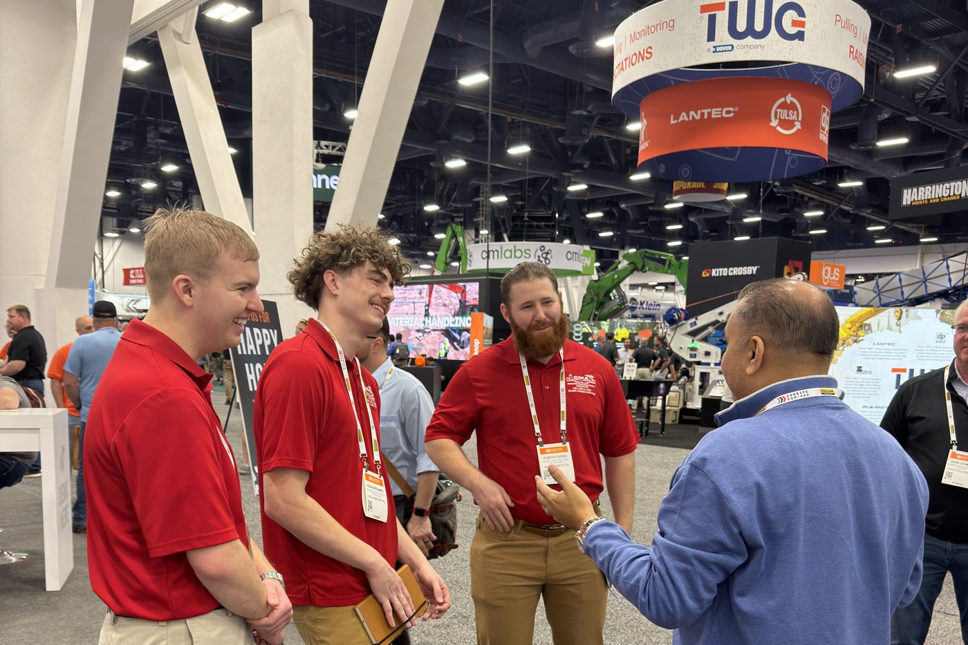 Zulq Malik talking with three visitors on the floor at ConExpo