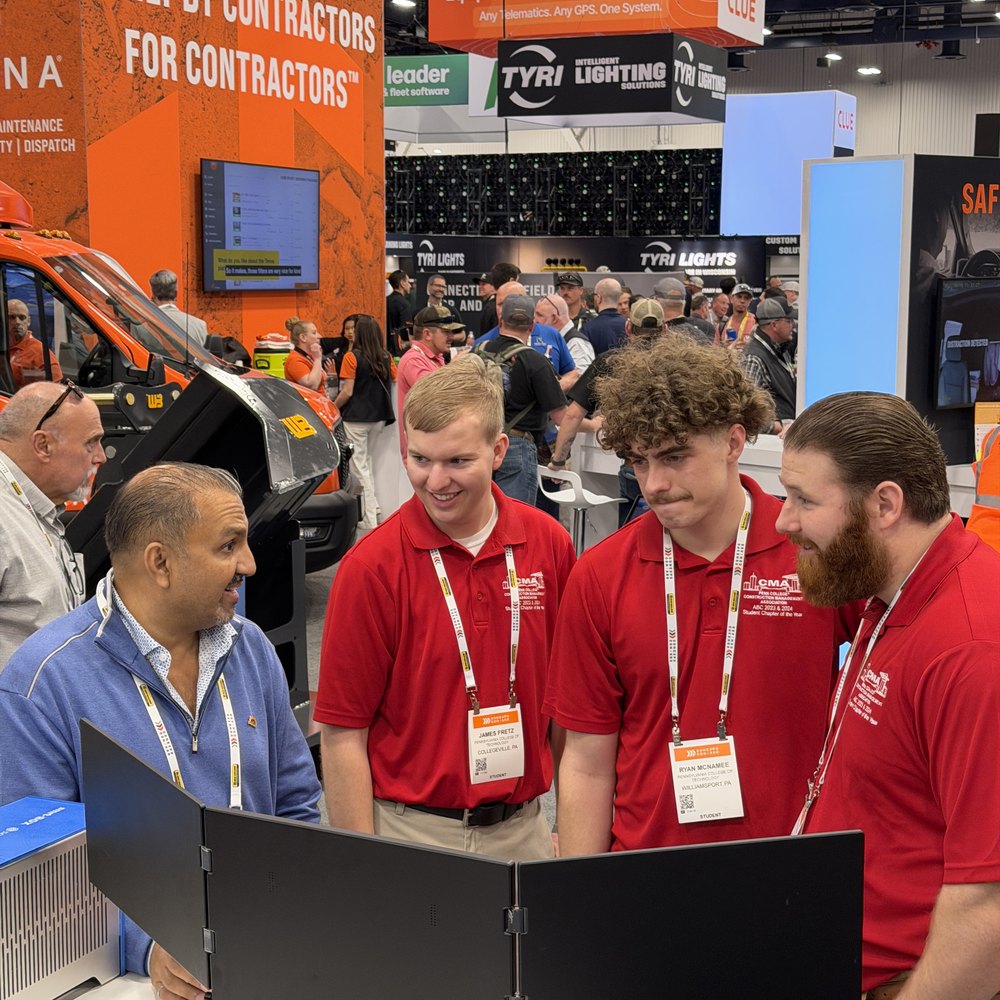 Zulq Malik walking three visitors through the platform at the SMARTBUILD booth