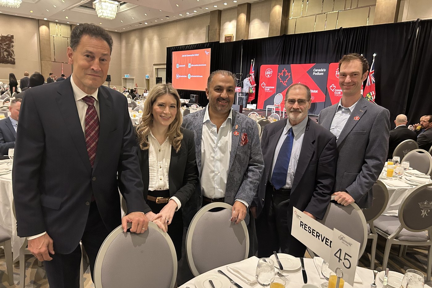 Zulq Malik with customers and industry guests at a conference breakfast