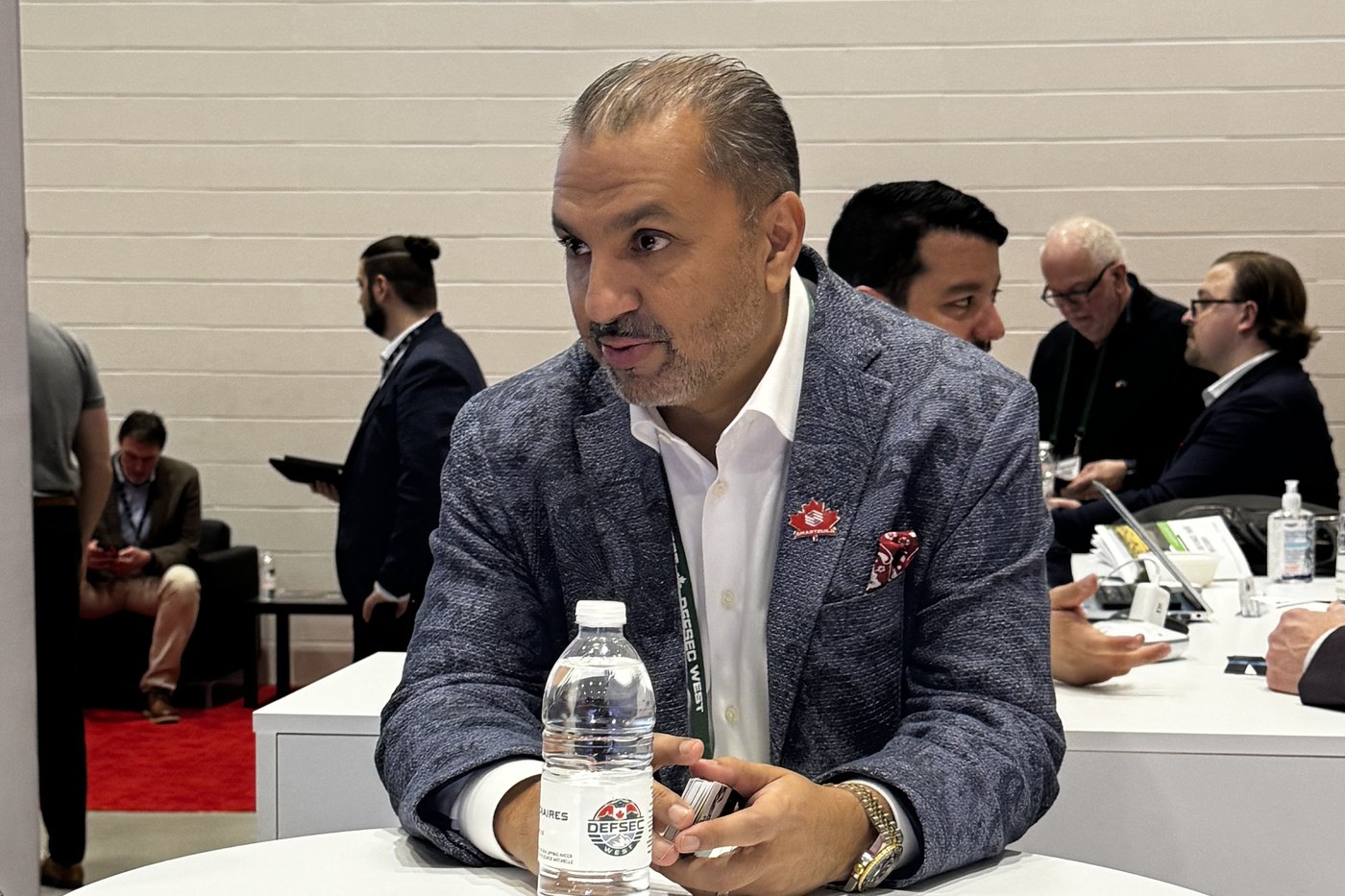 Zulq Malik in conversation at the SMARTBUILD table at DEFSEC West